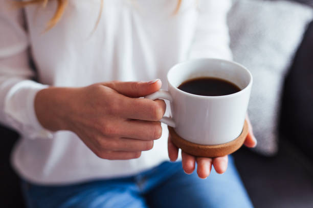 istock Female hands holding cup of coffee 935049452