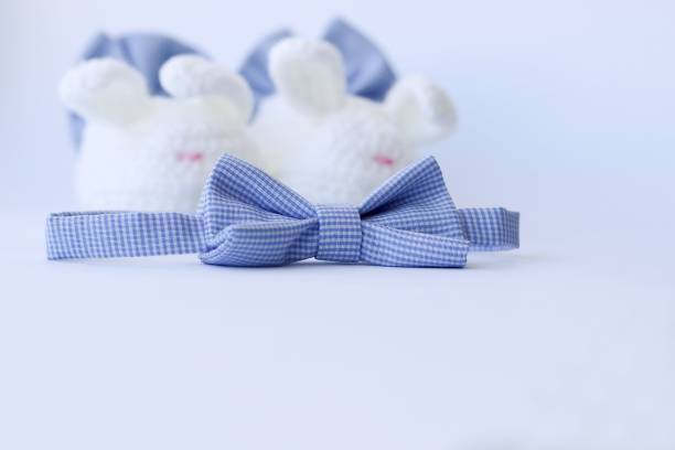 istock Cute newborn bow tie with blurry knit baby booties on background 935049454