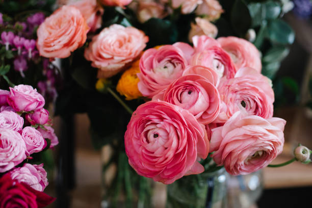 istock Beautiful and modern floral composition with anemones, roses, ranunculus and hydrangea with black and white matte paper at the city flower market 935049542