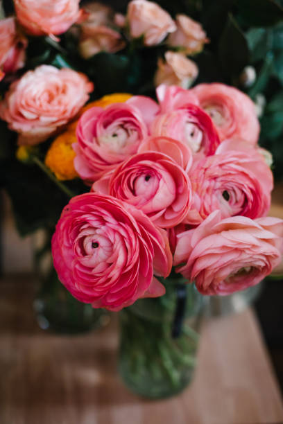 istock Beautiful and modern floral composition with anemones, roses, ranunculus and hydrangea with black and white matte paper at the city flower market 935049546