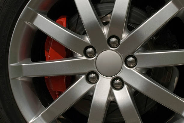 istock Alloy wheel with red brake calliper and five nuts 93505022