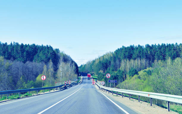 istock Bridge over river on road at countryside toned 935052816