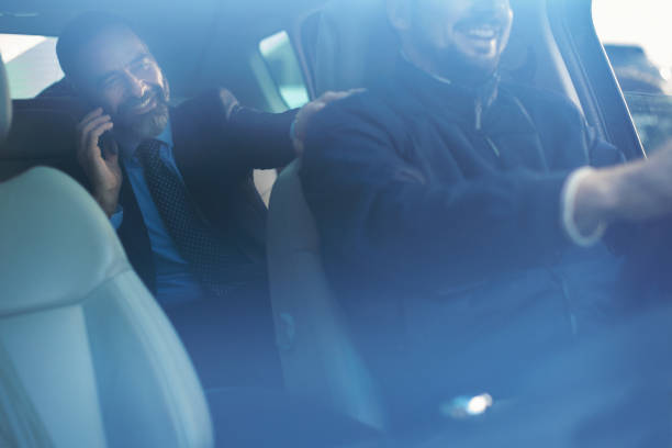 istock Senior businessman in car using smart phone 935057372