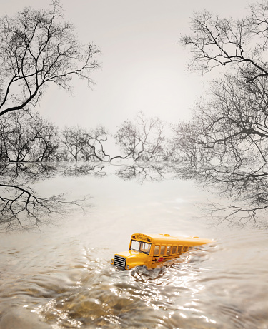 Yellow school bus ( toy model ) in flood.Natural disasters concept.