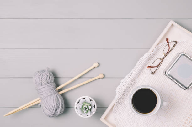 istock Knitting background with wool and needles on gray wooden table 935068972