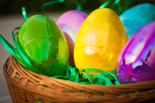 Multi-Colored Plastic Easter Eggs Sitting in a basket