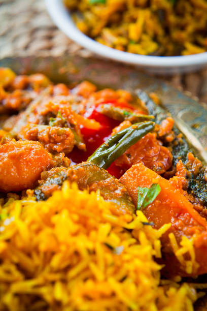 istock Indian Vegetable Curry with saffron rice on traditional metal plate. 935078266