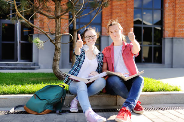 istock Young students show sight thumbs up and good luck 935078346