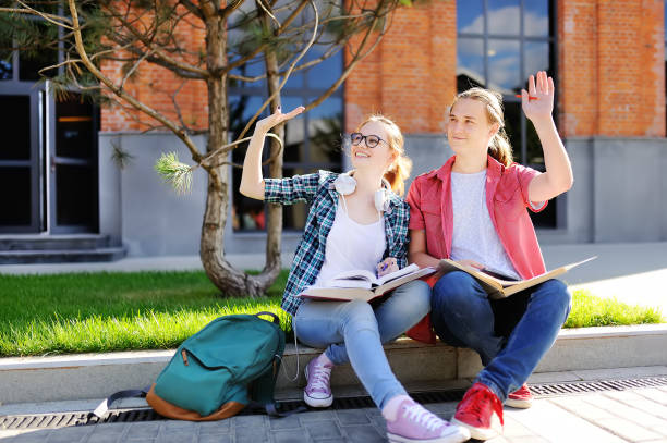 istock Young happy students with books and notes outdoors 935078420