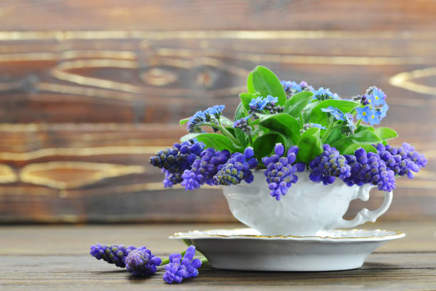istock Anniversary flowers. Spring flowers on wooden background 935083450