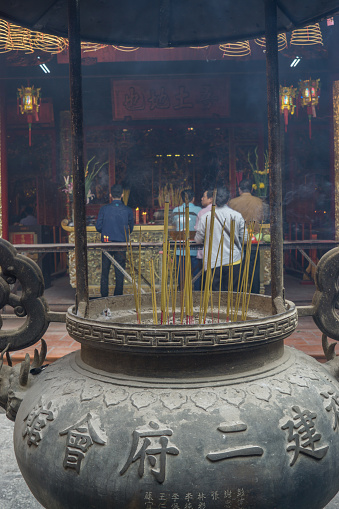 Ho Chi Minh City, Vietnam - February 27th, 2018: People visit the Buddhist temple during the Chinese New Year in Chinatown.