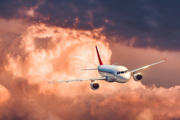 istock Beautiful airplane is flying in colorful clouds 935091342