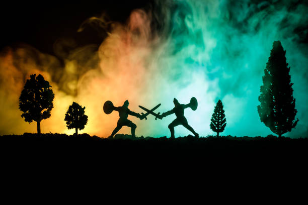 istock Medieval battle scene with cavalry and infantry. Silhouettes of figures as separate objects, fight between warriors on dark toned foggy background. Night scene. 935091682