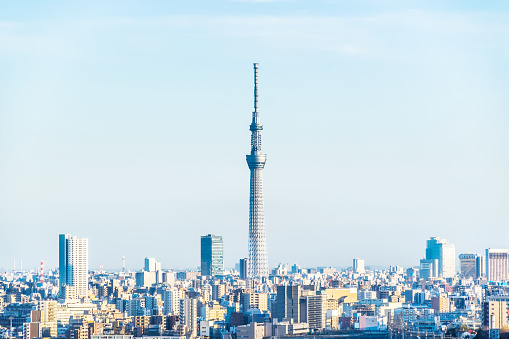 Asia Business concept for real estate and corporate construction - panoramic modern city skyline aerial view of oji, taito & sumida area with toky skytree, shinkansen railway under blue sky in Tokyo, Japan