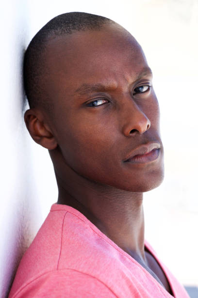 istock Close up handsome african man leaning against white wall 935110344
