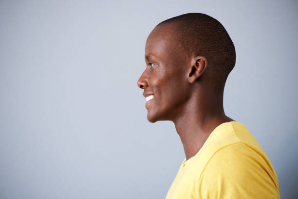 istock Close up profile 
of black man smiling against gray background 935110444
