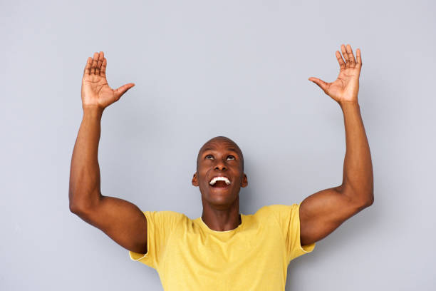 istock happy black man with arms and hands raised to lift 935110470