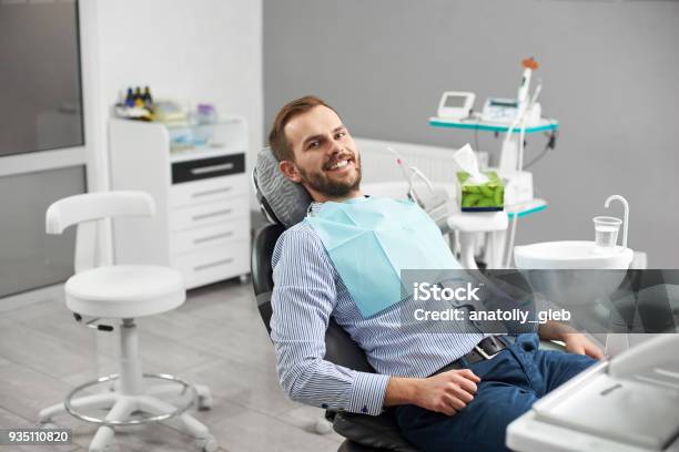 Portrait Of Happy Patient In Dental Chair Modern Dentistry With The Use Of New Technologies Stock Photo - Download Image Now