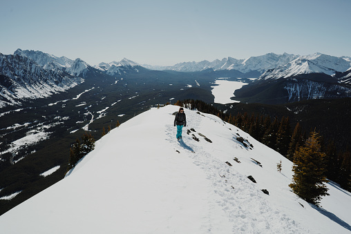 Girl reaches the summit of a mountain called Little Lawson in the Canadian Rockies.