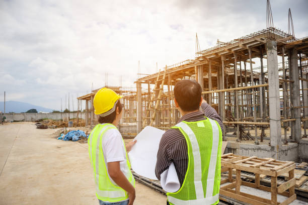 istock Asian business man construction engineer workers at house building site 935119690