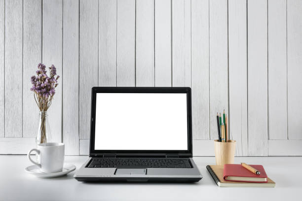 istock workplace background with Blank white screen modern laptop computer. White wooden vintage blackground 935138578