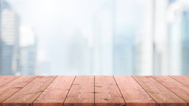 istock Empty wood table top and blur glass window wall building background with vintage filter - can used for display or montage your products. 935138738