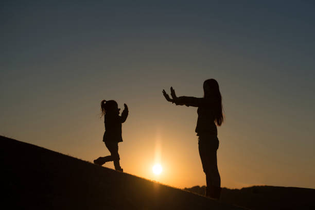 istock Mother and daughter silhouette 935150852