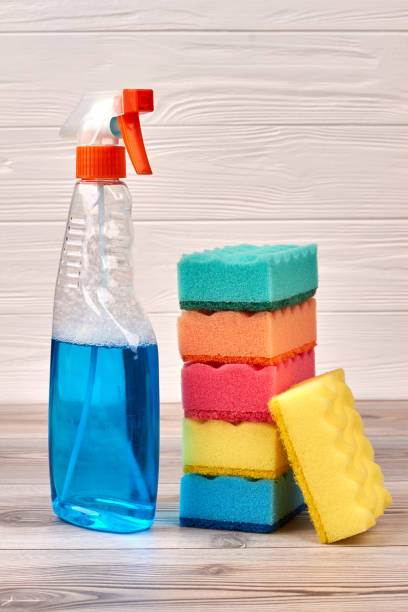 istock Cleaning sponges and plastic bottle of spray. 935150928