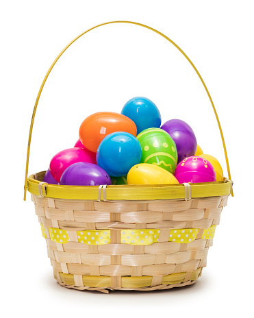 Multi colored Easter eggs in basket isolated on white background