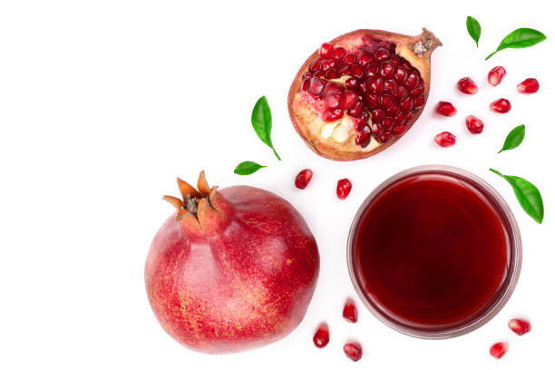 istock pomegranate juice with fresh pomegranate fruits isolated on white background with copy space for your text. Top view 935165072