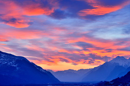 Swiss alps's valley at dramatic sky in sunset, Sion, Switzerland.