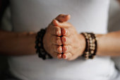 Woman hand yoga pose. Practicing meditation and praying indoors.