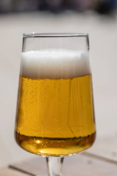 istock Fresh blond beer on an outdoor grey background 935237774
