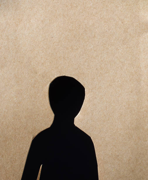 istock Man shape cut out of paper in hand 935241196