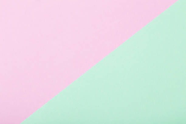 istock pink and green paper background 935241858