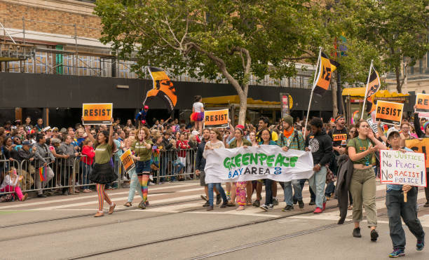 Greenpeace at the 2017 San Francisco Pride Parade. SAN FRANCISCO, CA – JUNE 25, 2017: Greenpeace Bay Area procession at the 2017 San Francisco Gay Pride Parade. greenpeace stock pictures, royalty-free photos & images