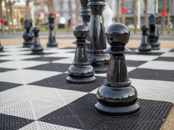 istock A black chess set in on a giant chess board 935244932