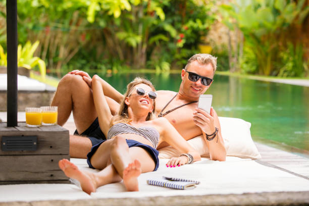 istock Couple chilling out by the pool on vacation 935245676
