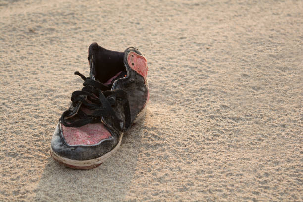 istock Old shoes on the beach. 935246232