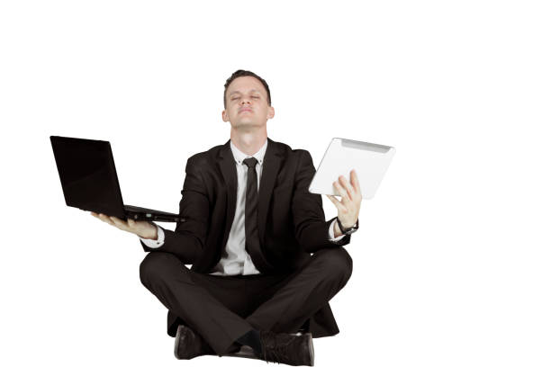 istock American businessman meditating with laptop 935251010