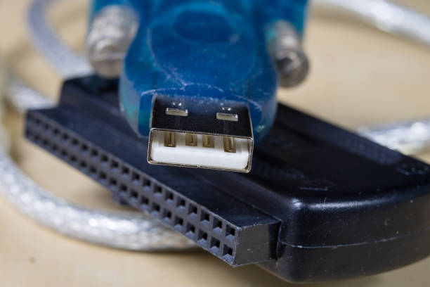IDE and USB socket on a wooden workshop table. Computer connectors used in electronics. Dark background.
