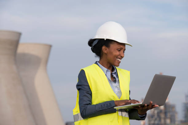 istock Woman engineer checking data of oil refinery via laptop with wireless connection. 935254666