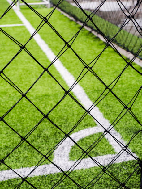 istock football field, corner side, made from synthetic lawn, behind the net, selective focus 935262066