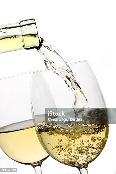 White Wine Being Poured Into A Glass On A White Backdrop Stock Photo - Download Image Now