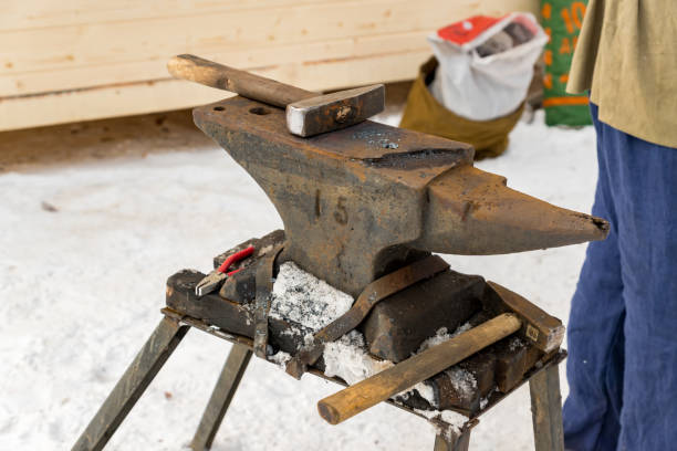 istock blacksmith manually forging the molten metal on the anvil outdoors 935267794