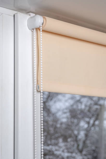 istock Beige blackout roller blind on the window 935271286