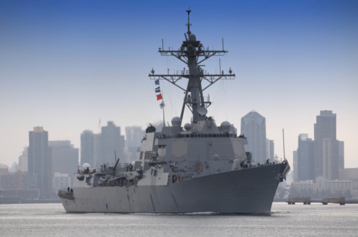 New York City, NY, USA- May 20, 2015: Members of the crew stand on the deck of the USS Barry as it sails in the Parade of Ships during Fleet Week. 