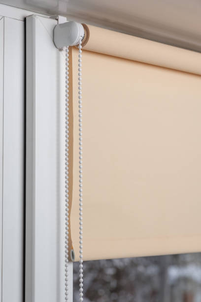 istock Beige blackout roller blind on the window 935271894
