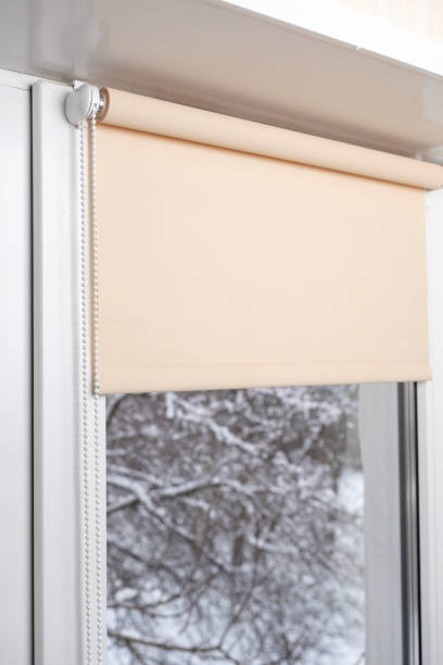 istock Beige blackout roller blind on the window 935271956