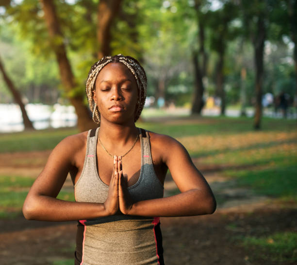 istock People yoga in a park 935271982